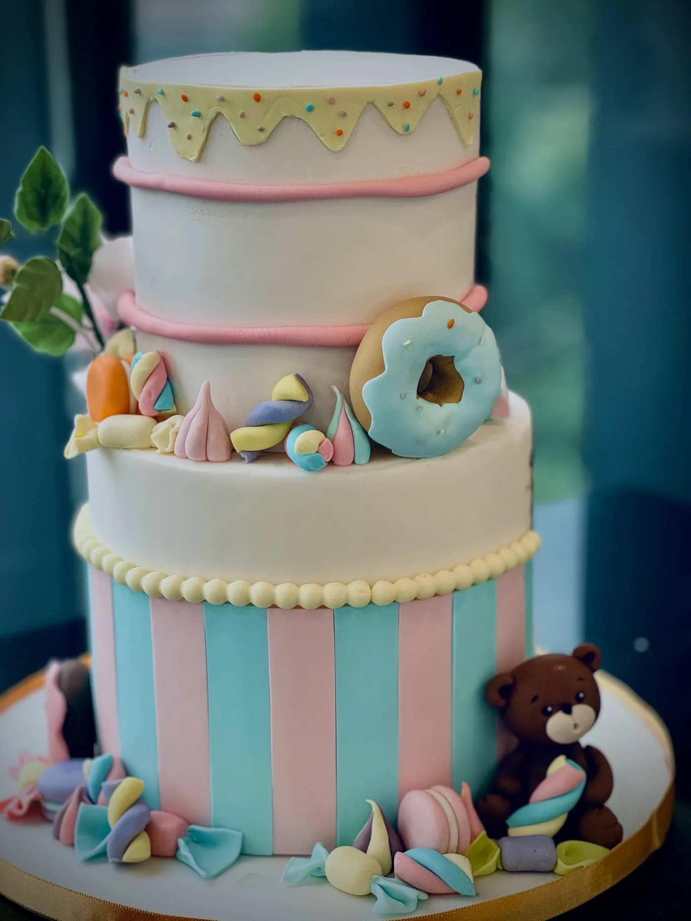 Candyland Celebration Cake — four-tier pastel fondant cake with sugar candy, donut and fondant teddy